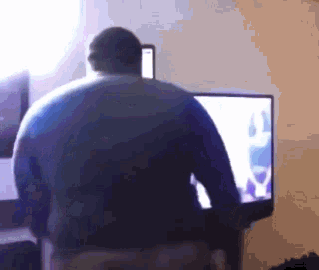 a man is standing in front of a flat screen tv