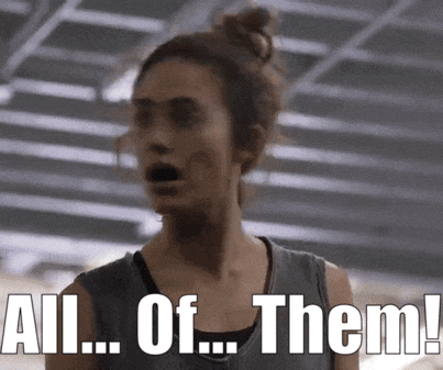 a woman is standing in a gym with her mouth open and says all of them !
