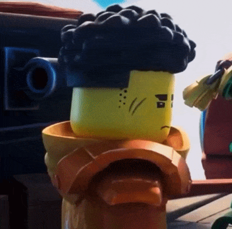 a close up of a lego figure with a sad face and a black hair .