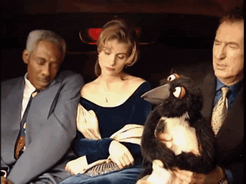 a woman in a blue dress holds a stuffed animal in her lap