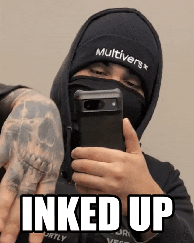 a man wearing a multiverse beanie takes a selfie