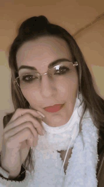 a woman wearing glasses and a face mask