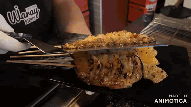 a person is cutting a piece of meat on a cutting board that says made in animotica on the bottom