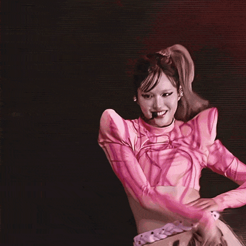 a woman with red hair is dancing on stage