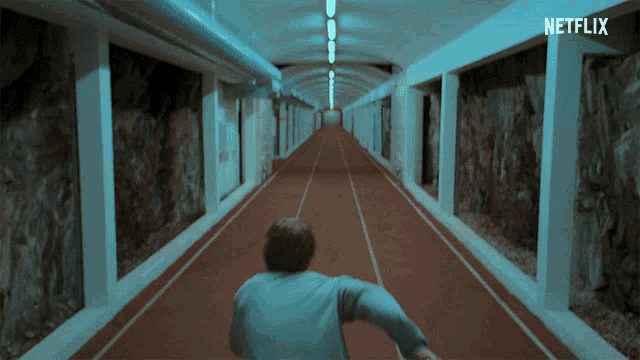 a person running down a hallway with a netflix logo in the corner
