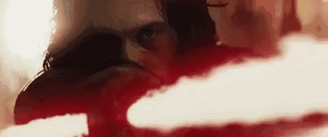 a close up of a person 's face with a red light coming out of it .