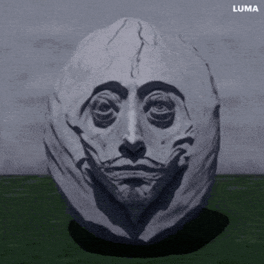 a statue of a man 's face is displayed on a green surface with luma written on the bottom