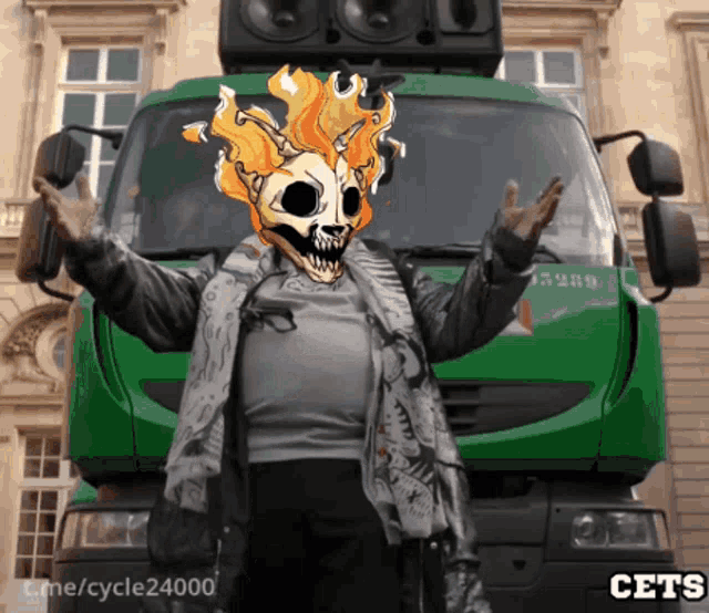a person with a skull on their face stands in front of a green truck
