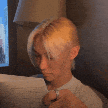 a person covering their face with a piece of paper that says ' i 'm sorry ' on it
