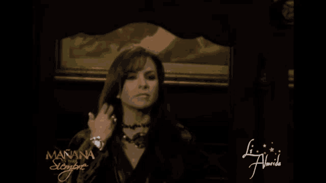 a woman stands in front of a mirror with the words manana siempre on the bottom
