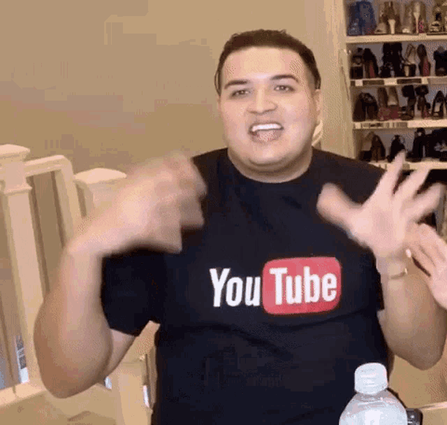 a man wearing a black t-shirt that says youtube on it