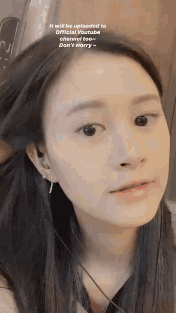 a close up of a woman 's face with the words " it will be uploaded to official youtube channel "