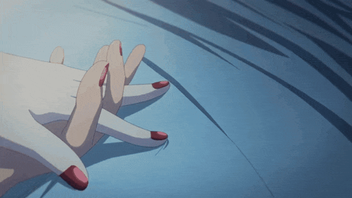 a close up of a person 's hands with red nails on a blue surface
