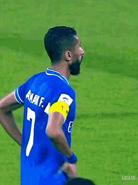 a soccer player wears a blue jersey with the number 1 on it