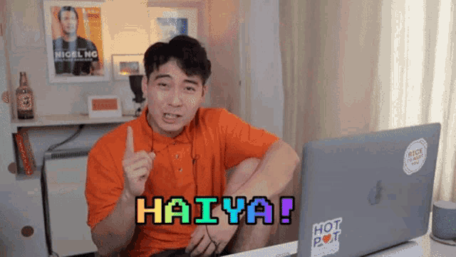 a man sitting in front of a laptop with haiya written on it