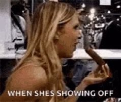 a woman is eating a doughnut in a restaurant while sitting at a table .