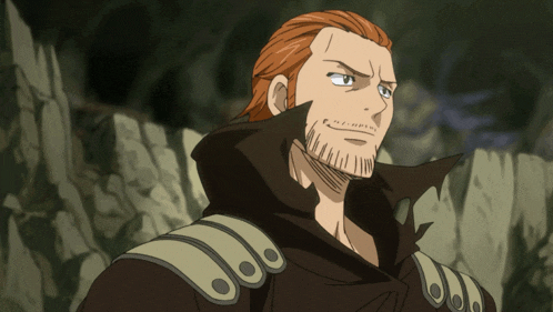 a man with red hair and a beard is wearing a black coat