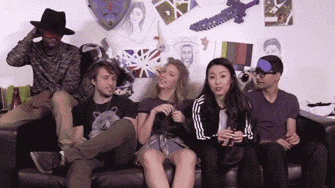 a group of people are sitting on a couch in front of a wall .