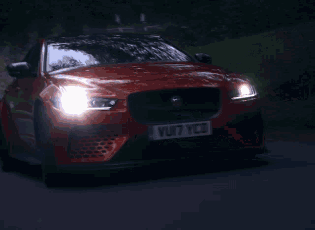 a jaguar car with a license plate that says vuji7 ycd