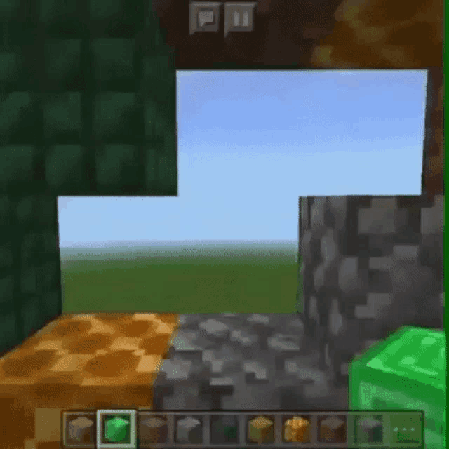 a person is playing a video game on a cell phone with a green block in the middle of the screen .