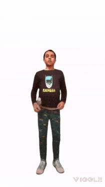 a young boy wearing a batman shirt walking