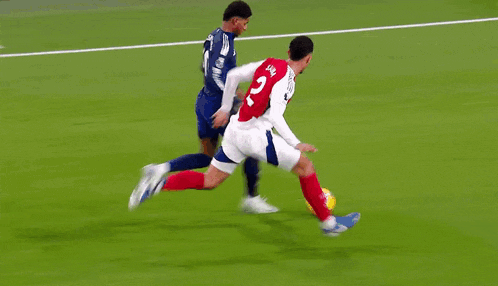 a soccer player in a red jersey with the number 2 on it