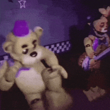 a teddy bear wearing a purple hat is standing next to another teddy bear in a dark room .