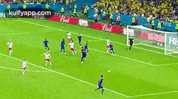 a soccer game is being played on a field with ads for kulfyapp.com