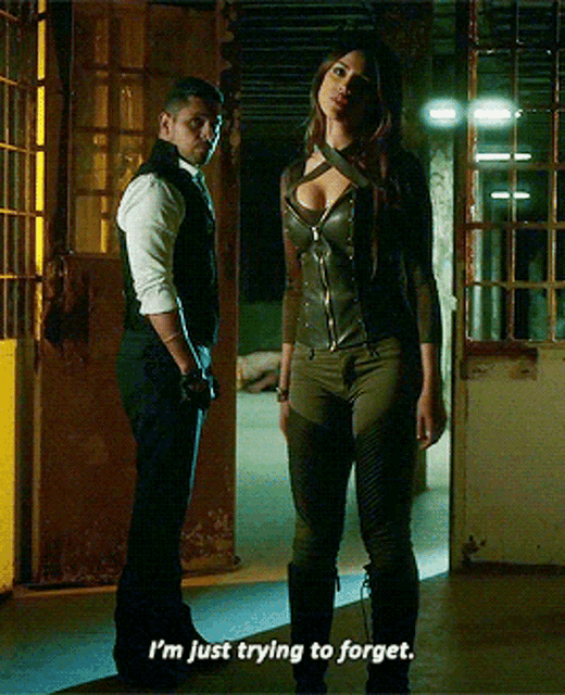 a man and a woman are standing next to each other and the woman is saying i 'm just trying to forget