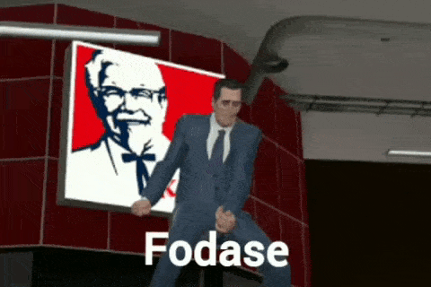 a man in a suit and tie is dancing in front of a kfc poster .