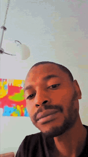 a man with a beard is looking at the camera