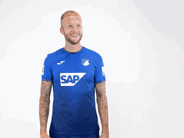 a man is wearing a blue shirt with the word sap on it
