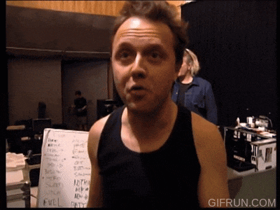 a man in a black tank top stands in front of a white board with the word evil written on it