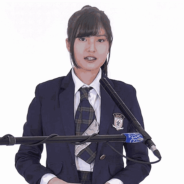 a girl in a suit has a badge on her jacket that says mml