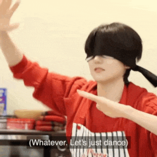 a person wearing a blindfold and an apron is dancing and says `` whatever , let 's just dance '' .