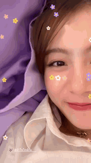 a woman with flowers on her face is smiling