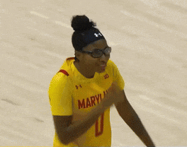 a female basketball player wearing a yellow jersey with the number 1 on it