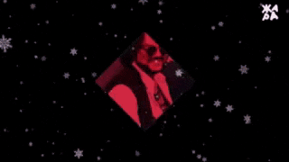 a man in a black vest is dancing in front of a red white and blue background