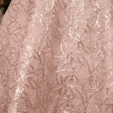 a close up of a woman 's hand on a pink dress