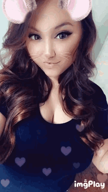 a woman is wearing a cat ear filter on her face .