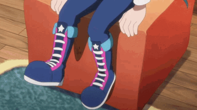 a person wearing a pair of blue and pink shoes with a star on the side