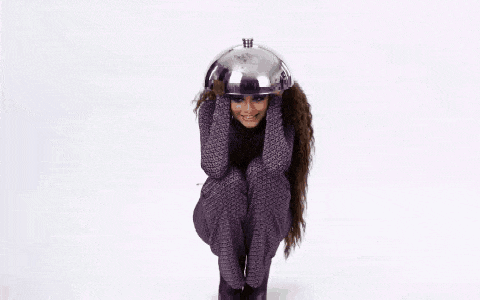 a girl wearing a helmet is surrounded by confetti and a cartoon monkey