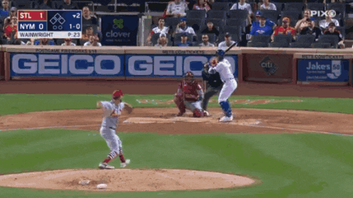 a baseball game is being played in front of a geico banner