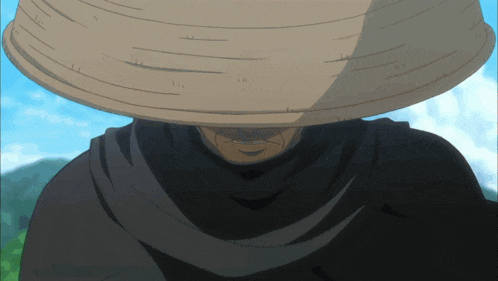 a man wearing a straw hat and a black scarf covering his face