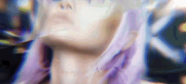 a close up of a woman 's face with purple hair and a blurry background
