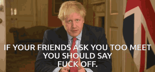 a man in a suit and tie is giving a speech