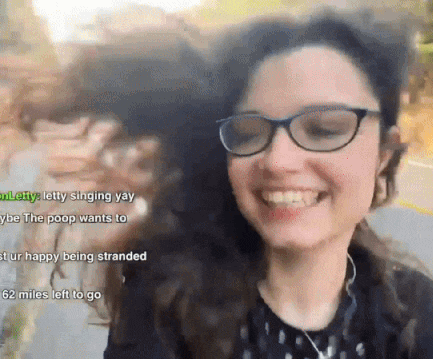 a woman wearing glasses is smiling with the words letty singing yay on the bottom