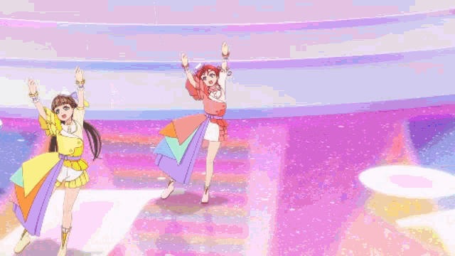 a group of girls are dancing on a stage with a rainbow in the background