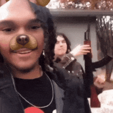a man with a dog mask on his face holds a shotgun