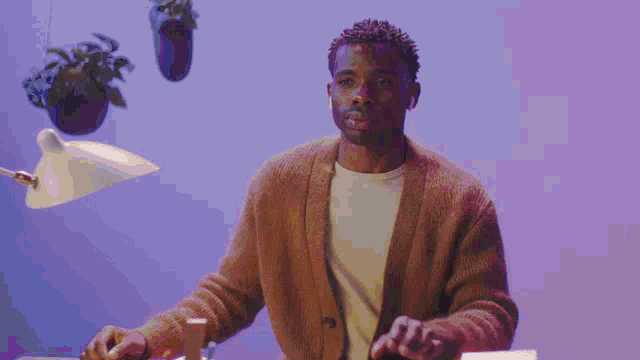 a man wearing headphones is sitting at a table with a woman